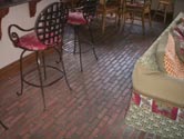 custom kitchen remodel with brick flooring and custom wood paneling