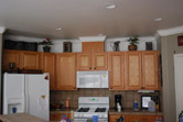kitchen remodel added crown moulding and wood paneling below bar countertop
